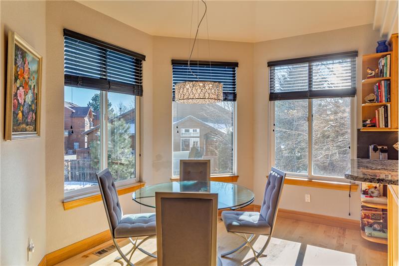 Eating area of kitchen overlooks back and side yards