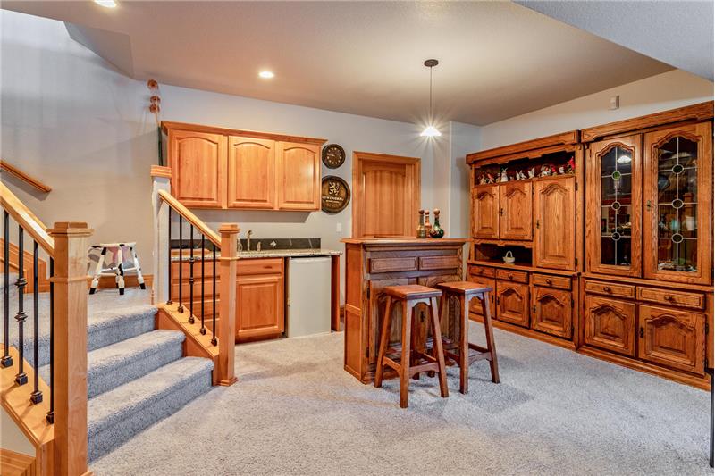Basement family room has a wet bar