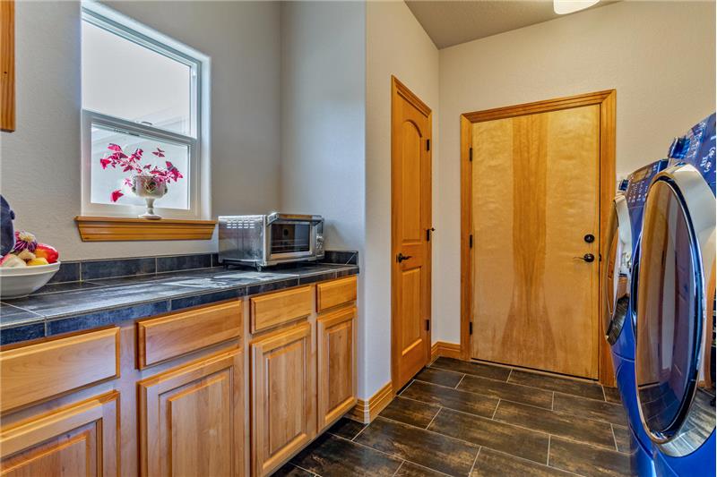 Laundry room serves as mudroom to garage. High efficiency washer & dryer on pedestals are included