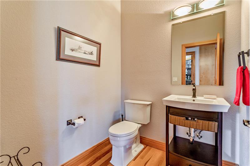 Powder room is between formal dining room and kitchen