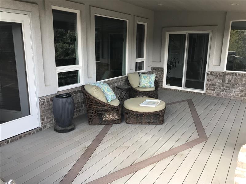 The covered deck outside the living room (left) and master suite (right) features an attractive design in the Trex decking. 
