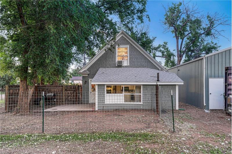 Rear view of home with fenced in dog yard