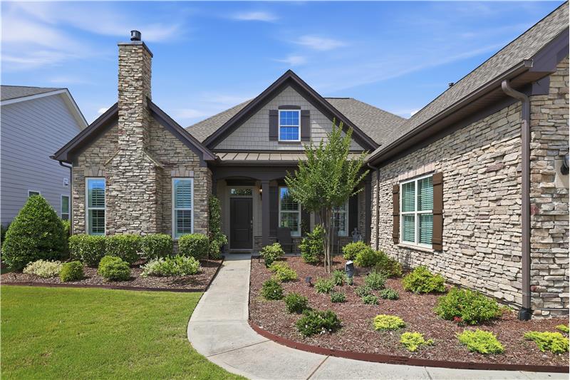Neutral color palette and beautiful landscaping give the home a timeless, elegant and welcoming feel.