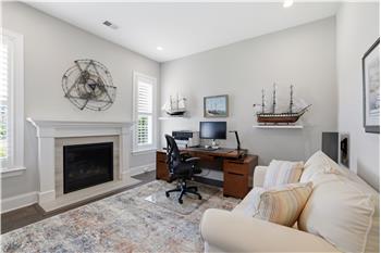 Currently a dedicated office. Neutral dcor, natural light, gas fireplace with decorative mantel create an inviting atmosphere.
