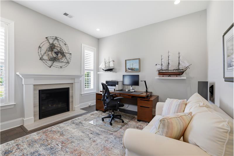 Currently a dedicated office. Neutral dcor, natural light, gas fireplace with decorative mantel create an inviting atmosphere.