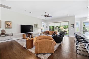 Open design keeps conversations flowing between living, dining, kitchen spaces. Easy access to the covered patio.