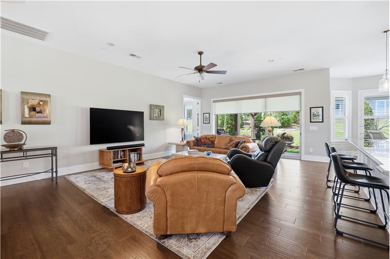 Open design keeps conversations flowing between living, dining, kitchen spaces. Easy access to the covered patio.