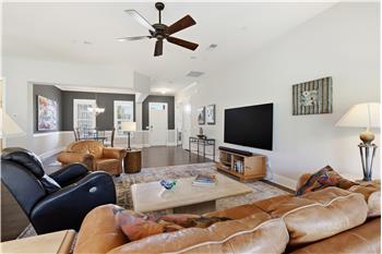 Generous living area with plenty of wall space for a large-screen TV, substantial furniture pieces, oversized art work.