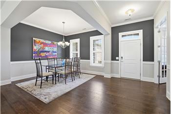 High ceiling, rich hardwood floors, crown molding, custom paint in entry create a warm, yet sophisticated first impression.