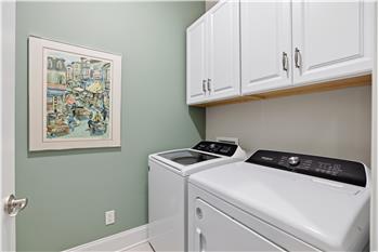 Laundry room with storage cabinets. There's also a utility sink with a storage cabinet above it.