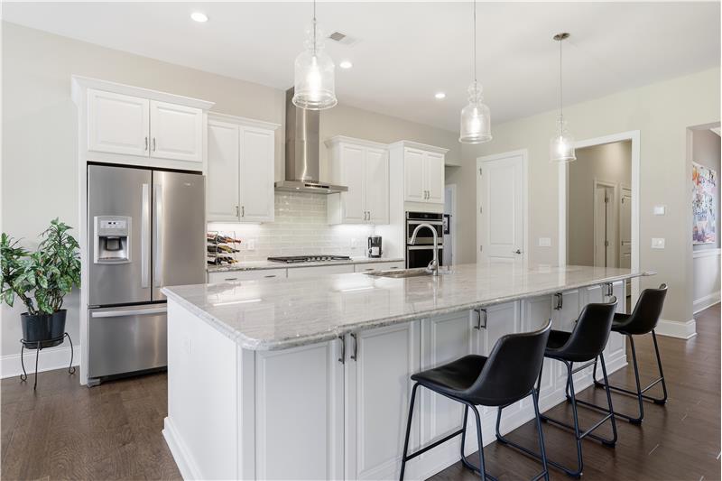 Spacious kitchen centered around oversized island is an entertainer's delight. Premium stainless appliances, sleek vent hood.
