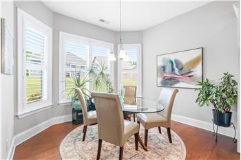Dining area adjacent the kitchen nestled in a bay of windows is ideal for daily meals and casual entertaining. Sits 6-8 easily.