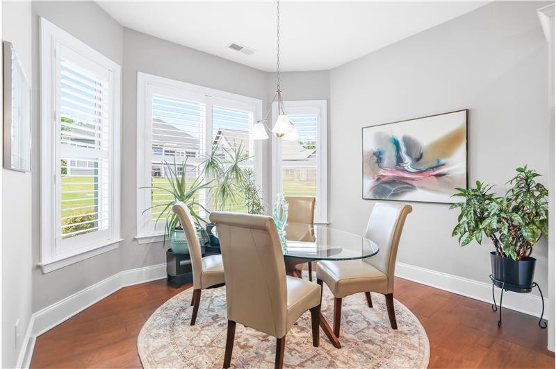 Dining area adjacent the kitchen nestled in a bay of windows is ideal for daily meals and casual entertaining. Sits 6-8 easily.