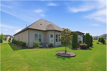Back view of home . Nice landscaping all around.