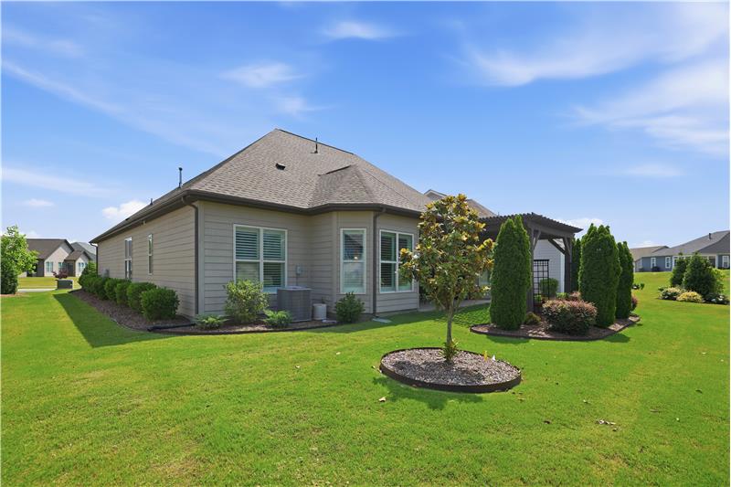 Back view of home . Nice landscaping all around.