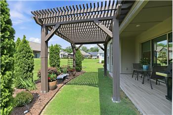 Pergola-covered garden area adds character and outdoor charm