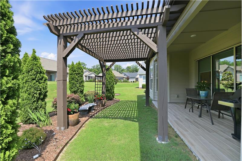 Pergola-covered garden area adds character and outdoor charm