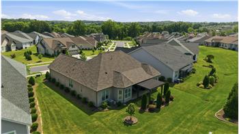 Aerial view of back of home and cul-de-sac street.
