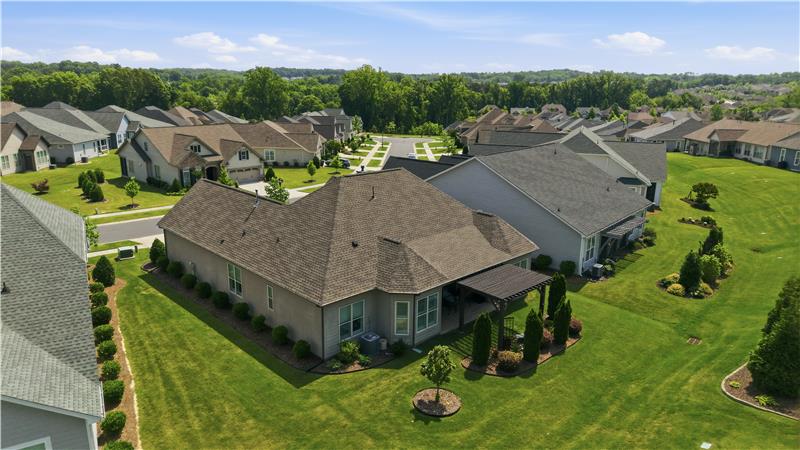 Aerial view of back of home and cul-de-sac street.