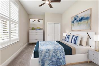 Bedroom currently used as a home gym virtually staged as a guest room.