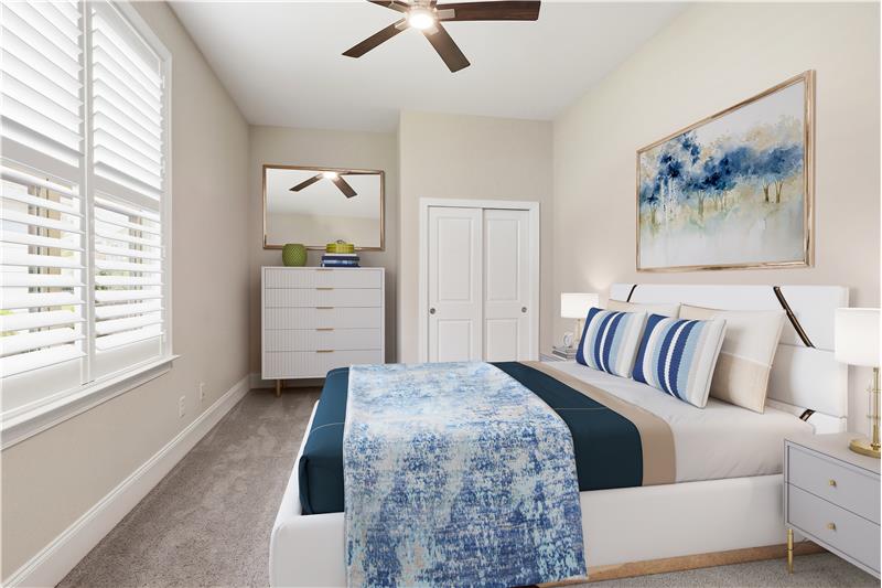 Bedroom currently used as a home gym virtually staged as a guest room.