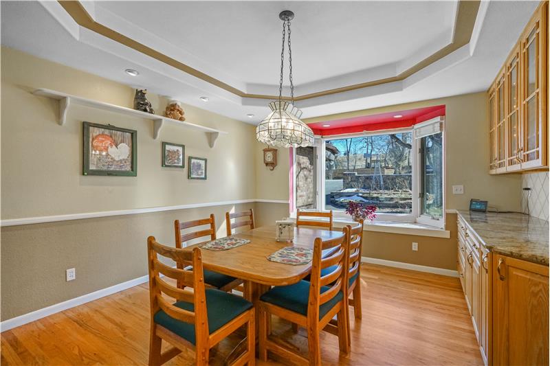 Dining room with double-cove ceiling, chandelier and bay window facing Wide Acres Road
