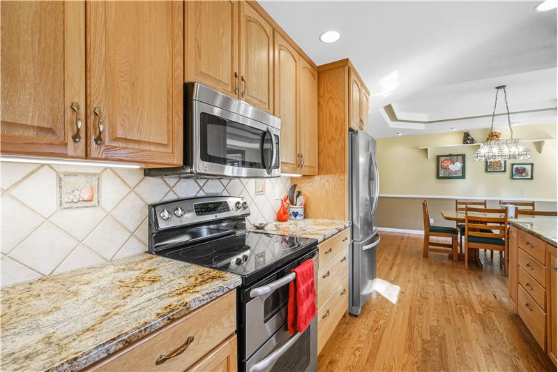 Updated kitchen has stainless steel appliances, including range with double oven.