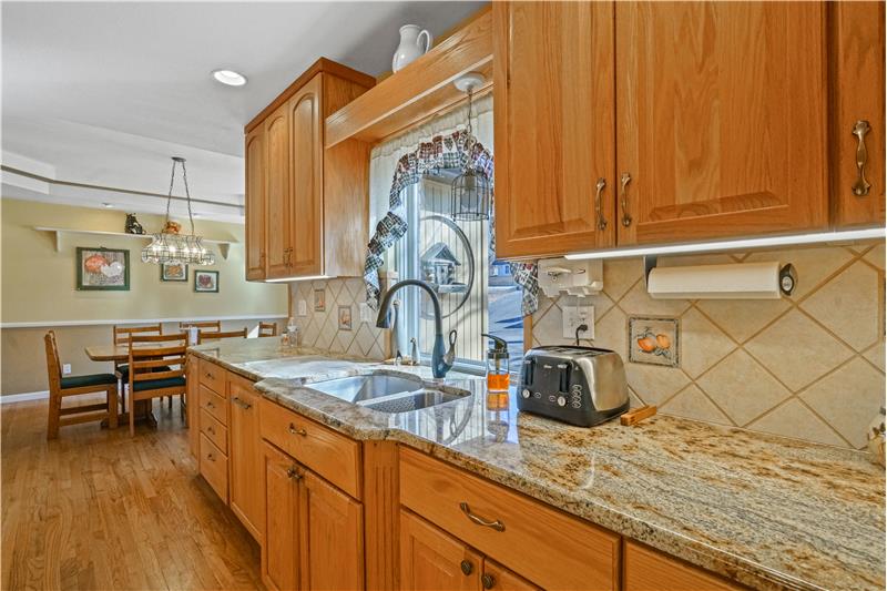 Note the slab granite countertops and under-cabinet lighting.
