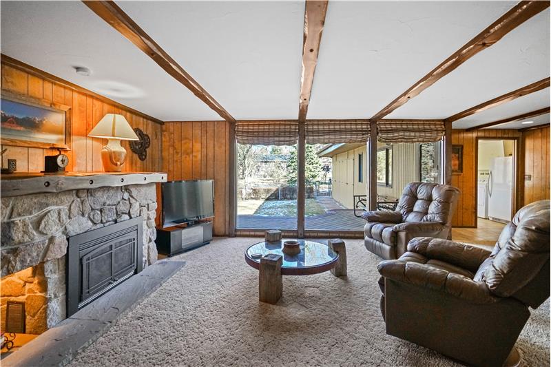 Large family room with stone fireplace (converted to gas). Windows to backyard.