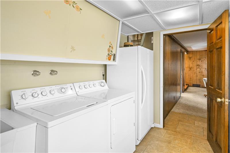 Laundry room with family room beyond. Washer and dryer are included.