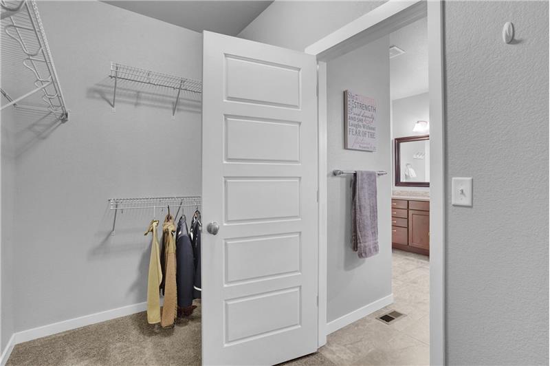 Primary walk in closet with access to the main level Laundry Room