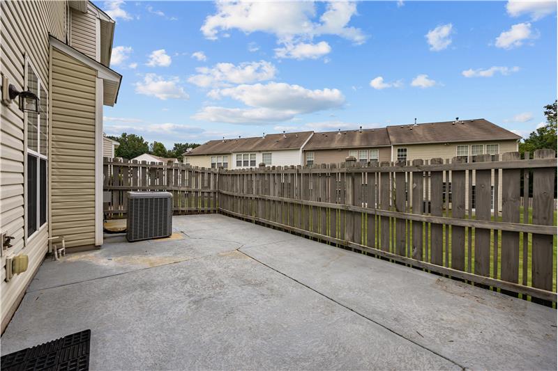 Sliding doors open to a private patio, a flexible space for container gardening or simply relaxing outdoors.