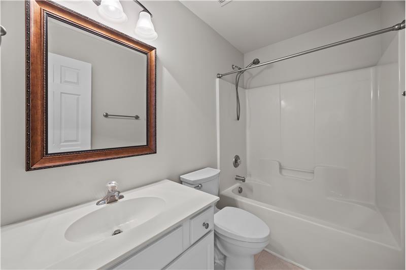 Hall bathroom shared by the two secondary bedrooms on the home's upper level.