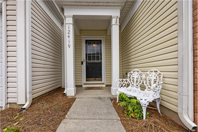 Covered front entrance features a storm door.