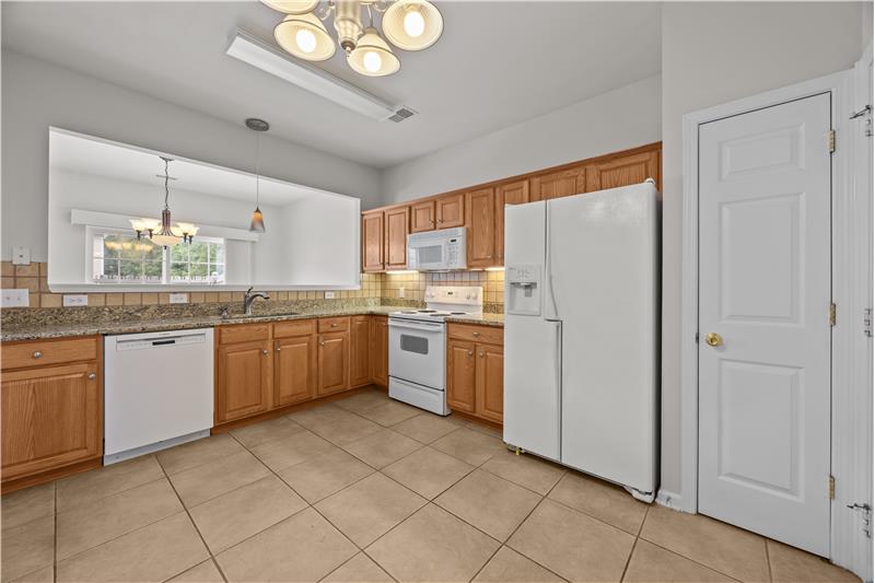 Functional kitchen layout with pantry provides a practical workspace for cooking.