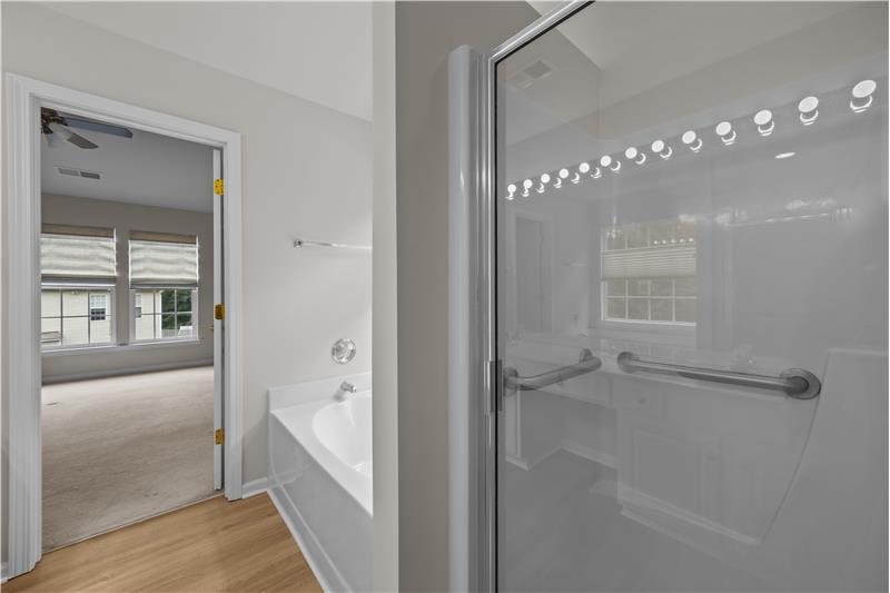 En-suite bathroom also features a separate step-in shower for convenience and ease.