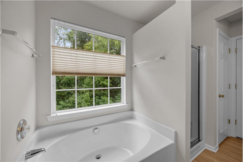 En-suite bathroom includes a soaking tub, perfect for unwinding at the end of the day.
