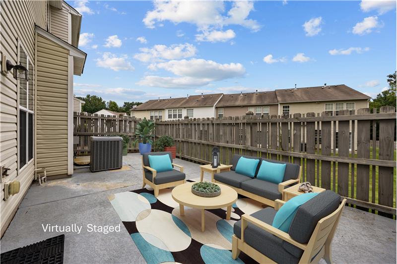 Private, fenced patio extends the living space outdoors, ideal for relaxing or casual gatherings.