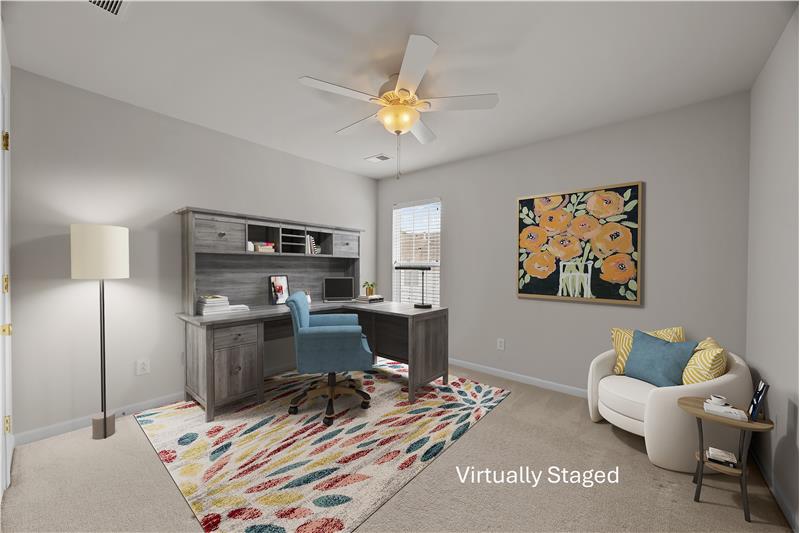 One of two additional bedrooms on the home's second floor shown as a home office.