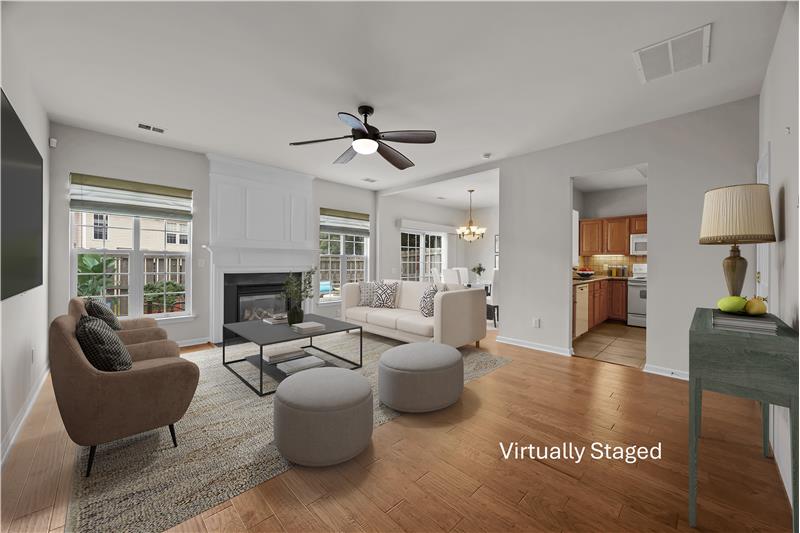 Generously-sized living room with fireplace and hardwood floors, an inviting setting for daily living and relaxed entertaining.