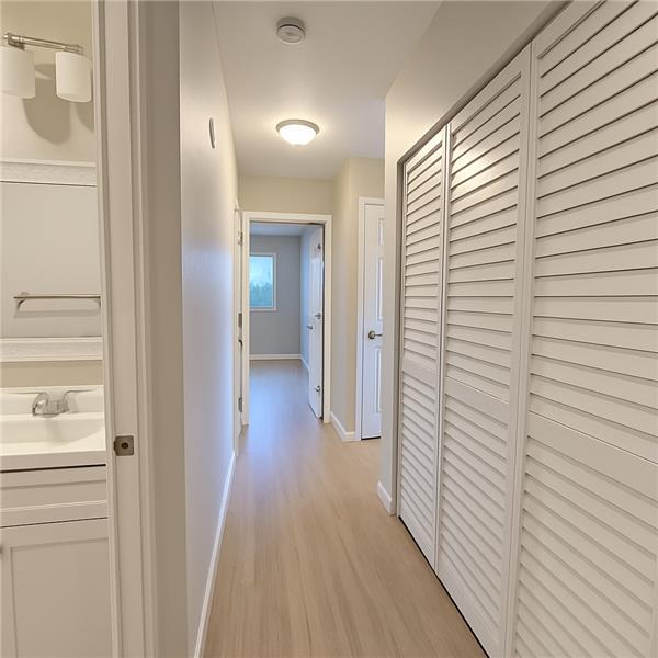 Hallway laundry space with washer and dryer