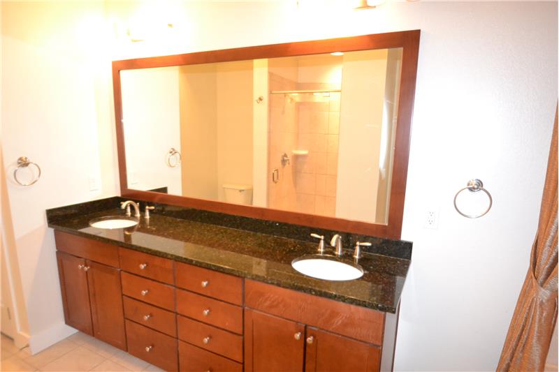 Master bathroom has double vanity set in a granite slab