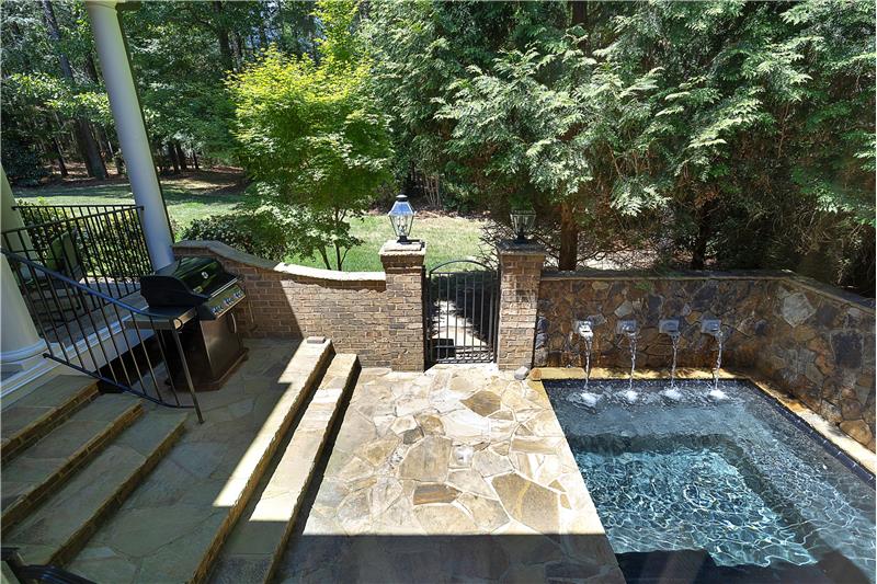 Off of the Covered Porch and Primary Suite  - Beautiful Built In Jacuzzi With Waterfall