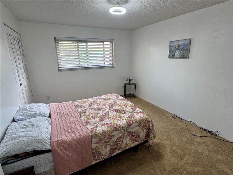 Guest bedroom has window to patio and carport