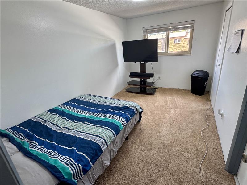 Primary bedroom has window to front yard and Youngfield Street