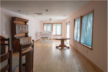 Light-filled living room area.  Several windows and doors to the expansive deck.