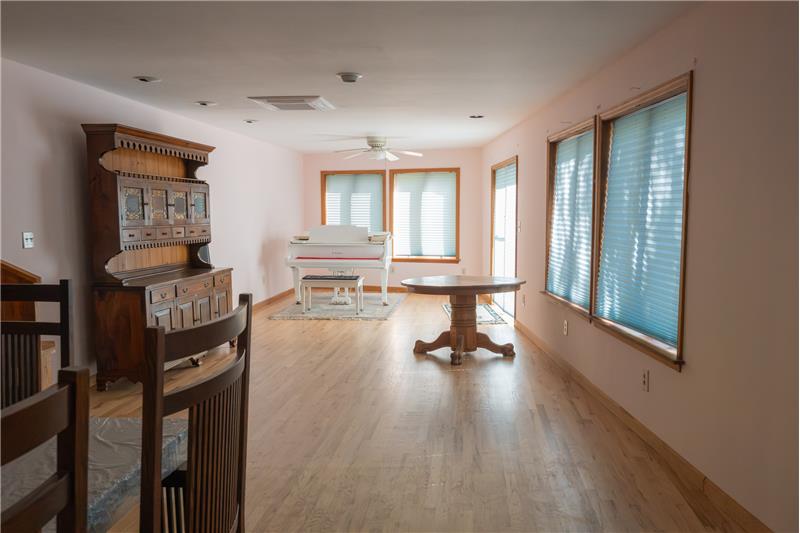 Light-filled living room area.  Several windows and doors to the expansive deck.