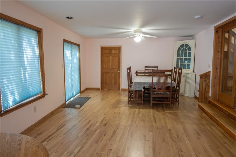 Dining area across from door to the deck, and door to the basement.