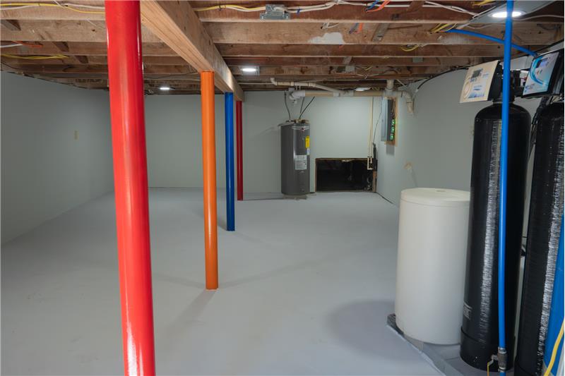 Basement area located under the  converted barn.  Location of water heater and  water treatment.
