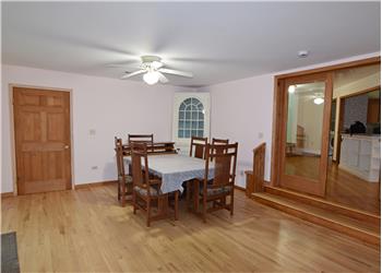 Dining room area with ceiling fan.